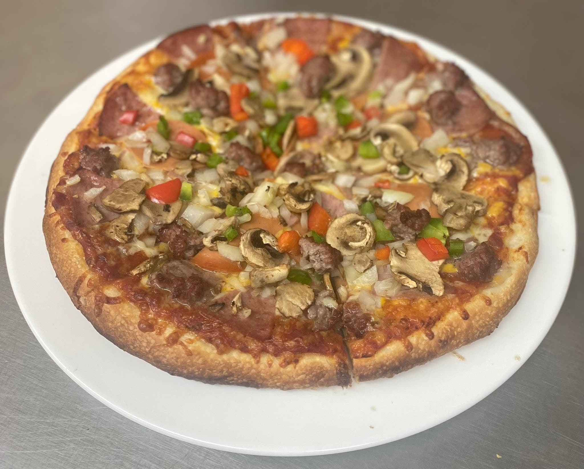 Bert's Works pizza loaded with vegetables and house meat