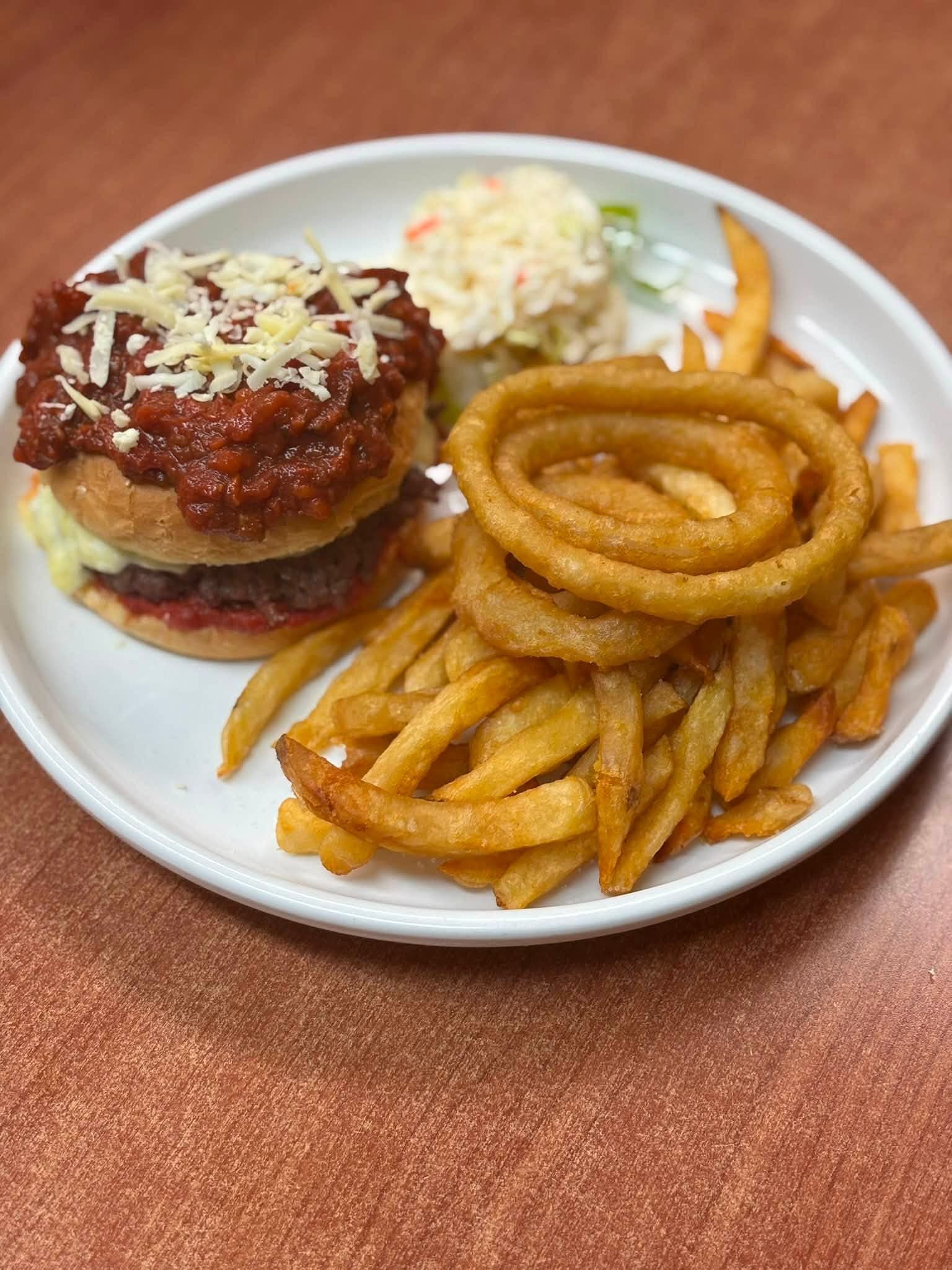 Bert's pizza burger with onion rings and fries