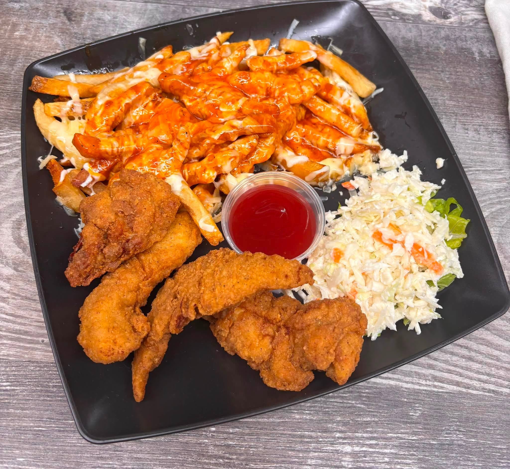 Bert's famous fried chicken tenders with loaded fries and coleslaw